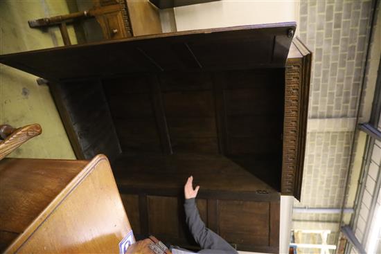 A carved and panelled oak wardrobe fitted two doors with matching compactum and dressing table, wardrobe W.104cm, D.55cm, H.178cm